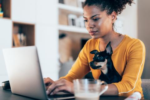 woman with dog at laptop