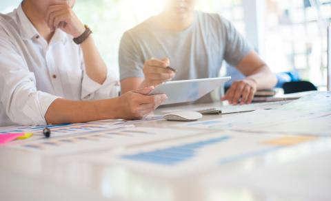 Two people meeting and reviewing information